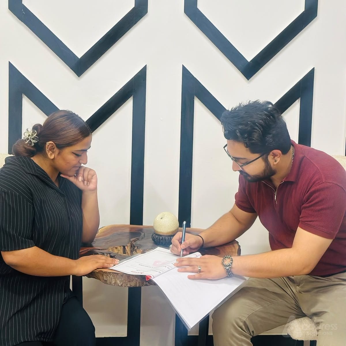 Client and consultant reviewing and signing legal property documents